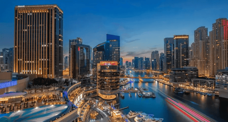 Modern Dubai cityscape featuring tall buildings and vibrant waterfront views.