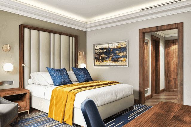 Elegant hotel room featuring a plush bed, stylish artwork, and contemporary furnishings in Ghana.