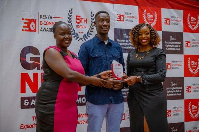 Jiji Kenya team receiving award for best e-commerce mobile app at Africa.com event.