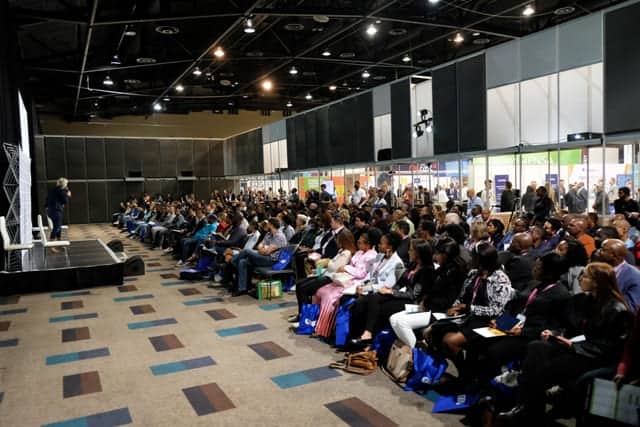 Large audience attending FMCG retail conference on trade innovation and future trends.