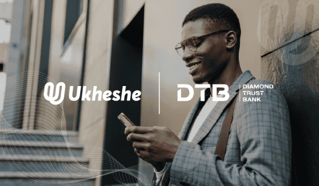Businessman using mobile payment app with Ukheshe and DTB logos in background.