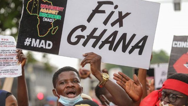 Motorbikers rally against petrol hikes with a "Fix Ghana" sign in Uganda.