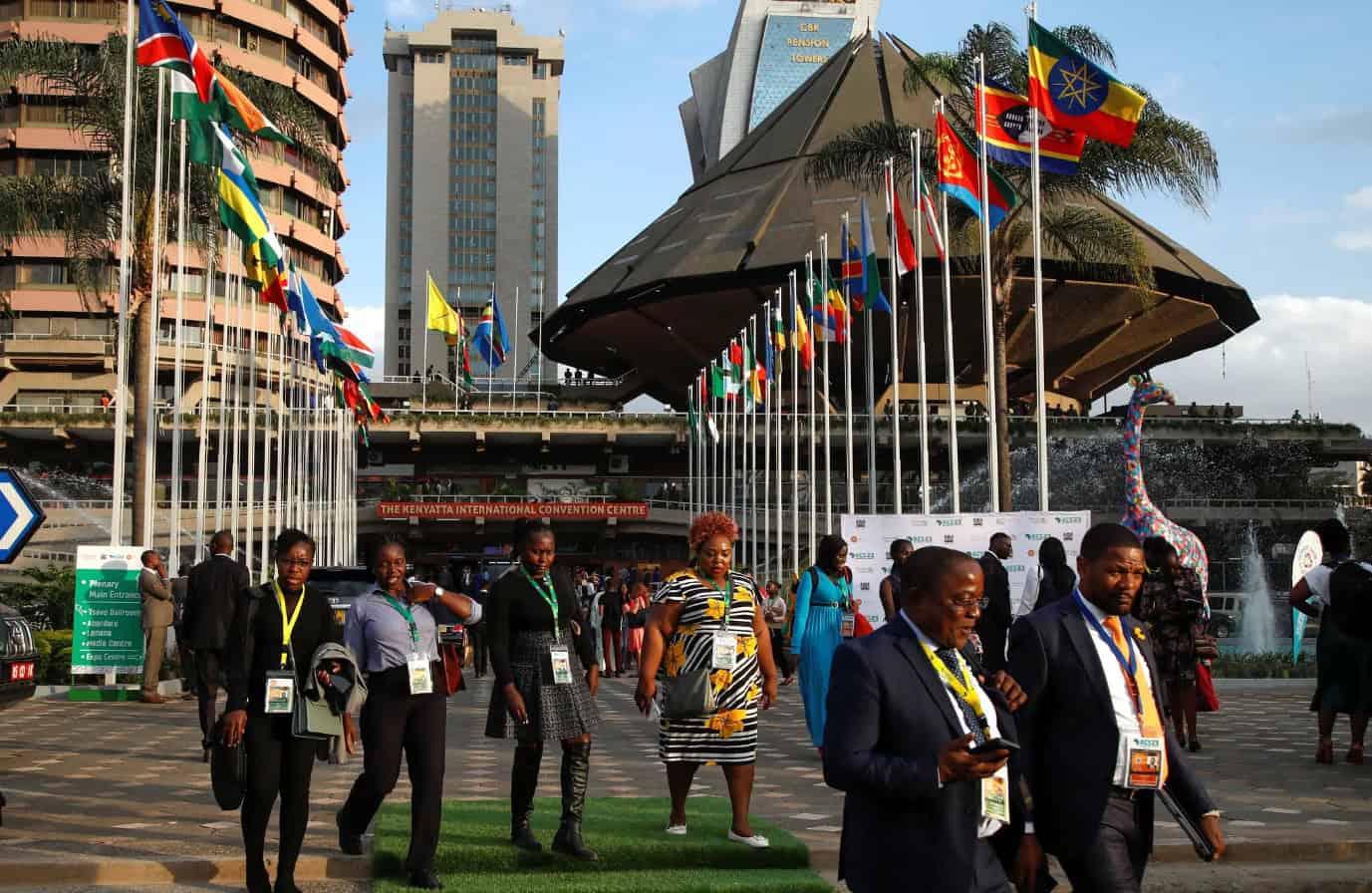 An image of delegates and attendees at the Africa Climate Summit, showcasing international flags and.