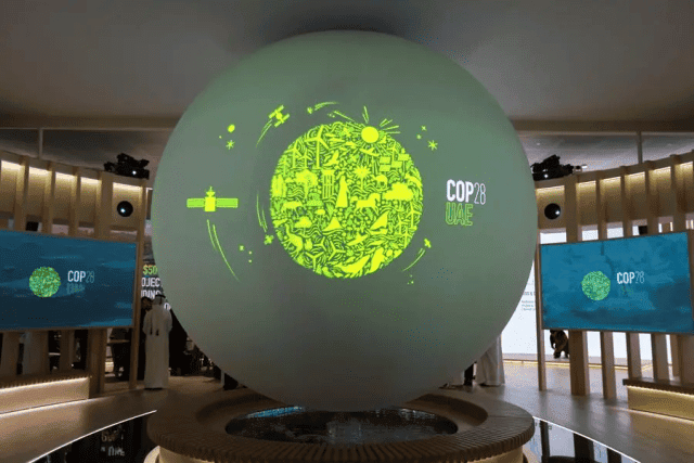 Interactive globe displaying climate goals at COP28 conference.