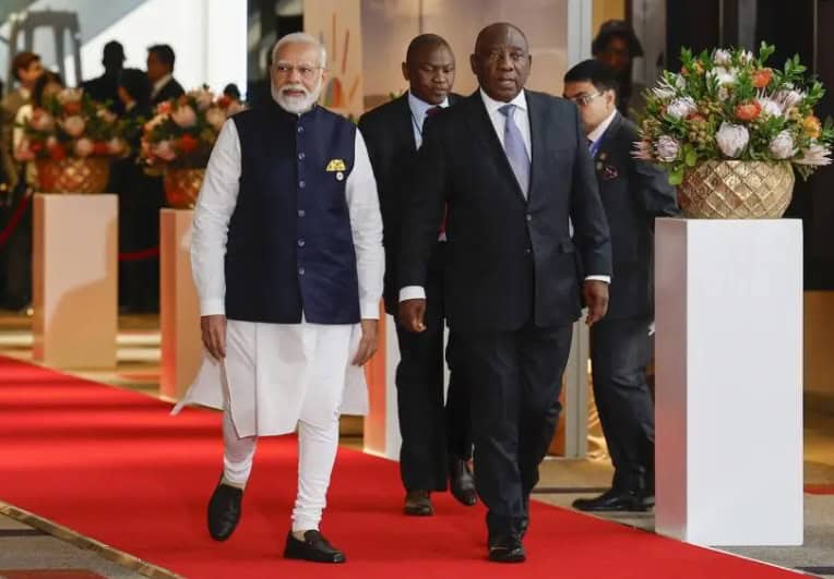 India's Prime Minister Narendra Modi and South African President Cyril Ramaphosa walking together on.