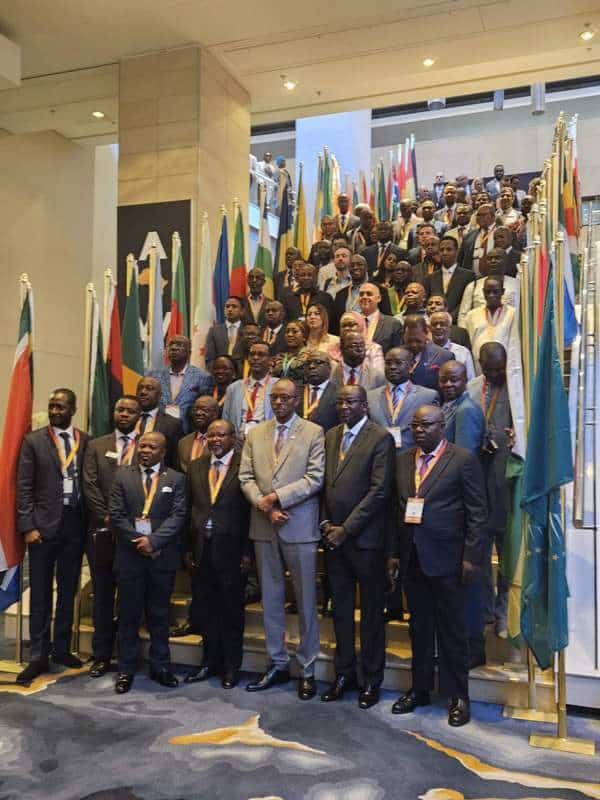 Africa energy transition summit with diverse delegates and flags.