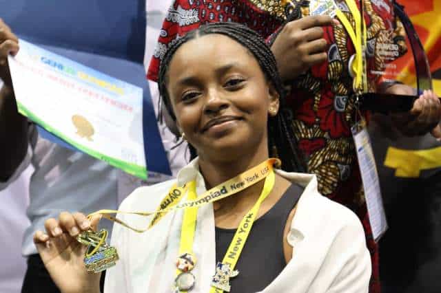 Young Angolan student proudly displays her medal at the GENIUS Olympiad in New York.
