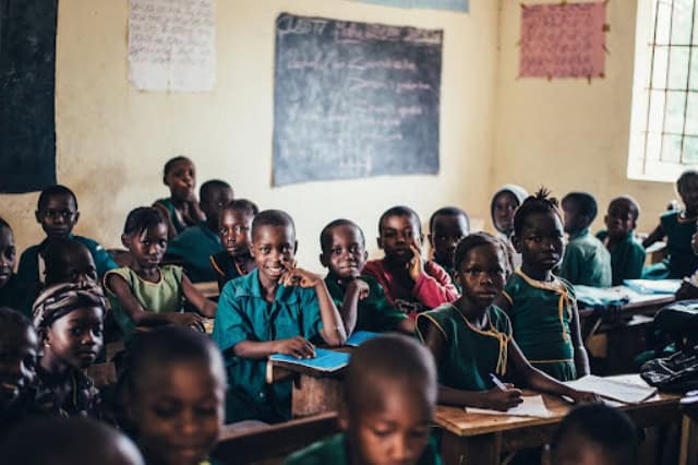 School children in Africa attending class with engaged expressions.