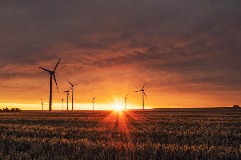 Wind turbines at sunset in Nigeria for energy development.