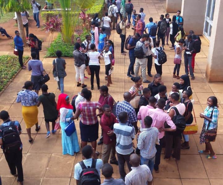 Students waiting in line at university entrance in East Africa.