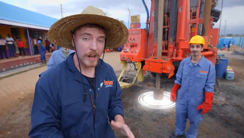 American YouTuber MrBeast in Africa building a well with local workers.