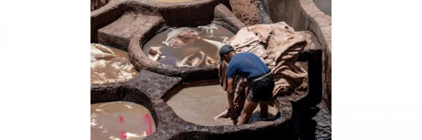 Ethiopian leather artisans working on traditional tanning processes.