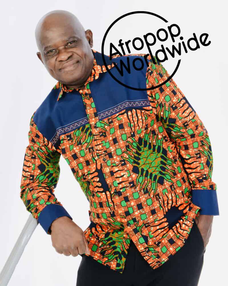 Celebrating Afropop music with a legendary artist in vibrant traditional attire.