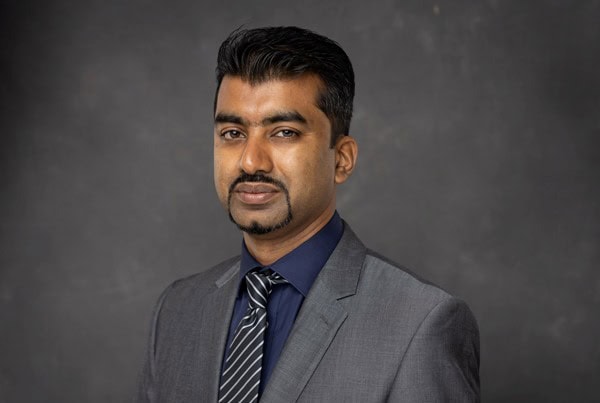 Airtel Africa executive in formal suit for digital transition.