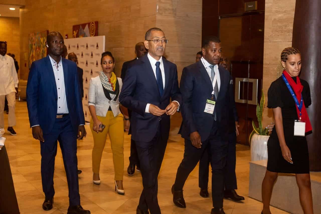 Industry leaders walking at Angola Mining Conference on sustainability and growth.