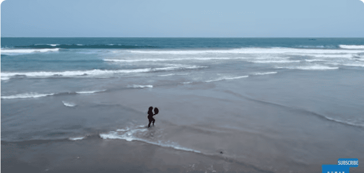 Person walking alone on a quiet Ghanaian beach promoting mental health awareness.