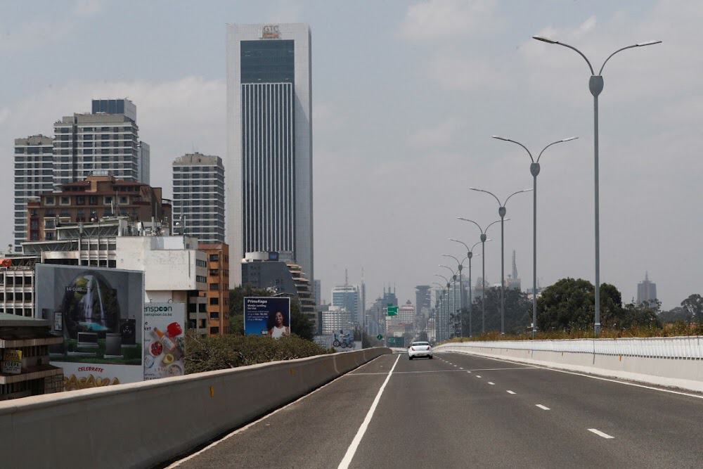 Modern African city skyline with skyscrapers and highway infrastructure.