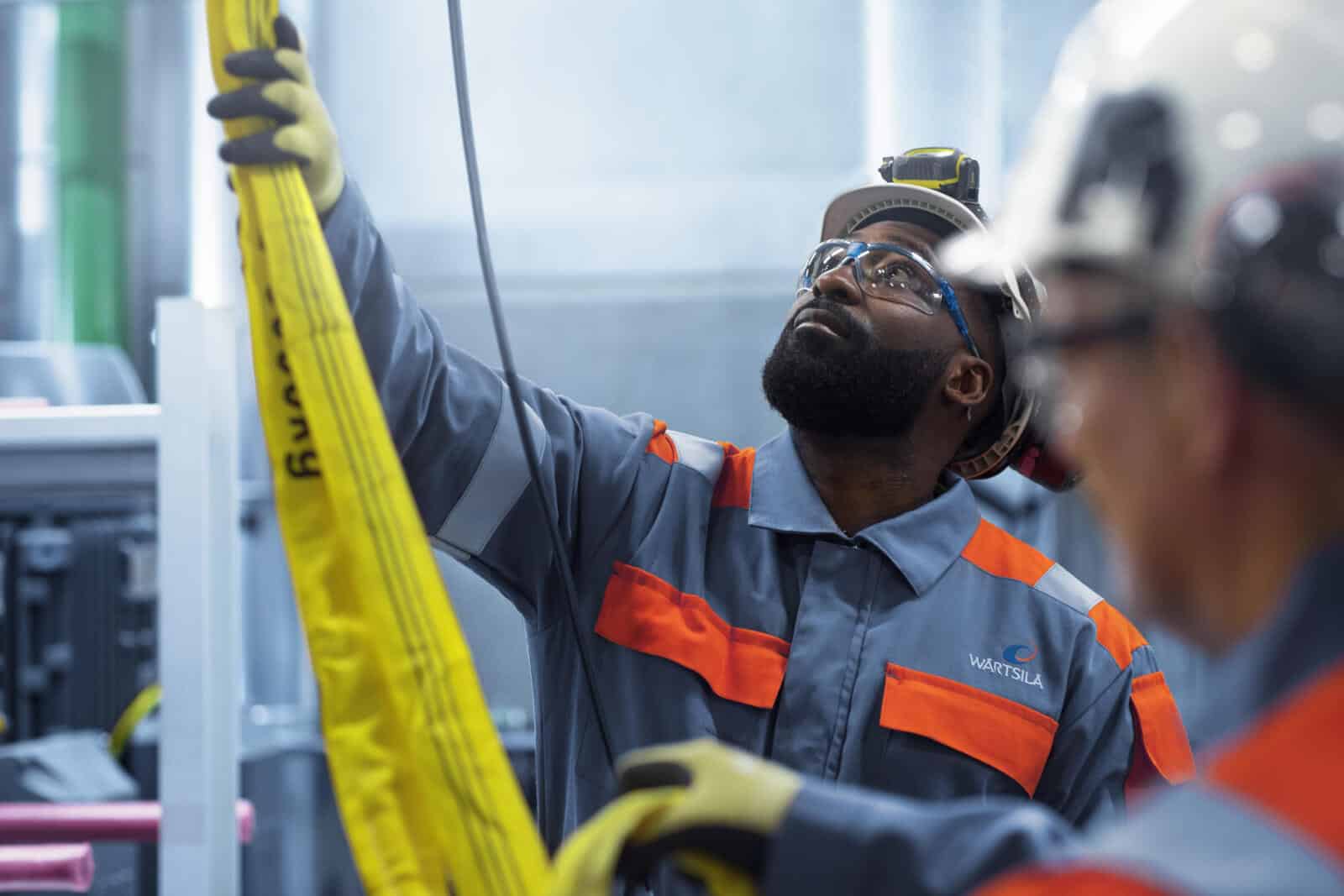 African industrial worker inspecting equipment for decarbonisation and energy efficiency.