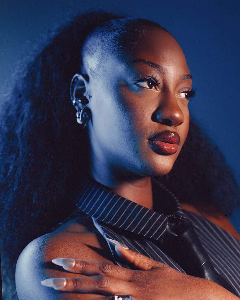 Tems, Nigerian singer and songwriter, in a striking portrait for her debut album "Born in the Wild".