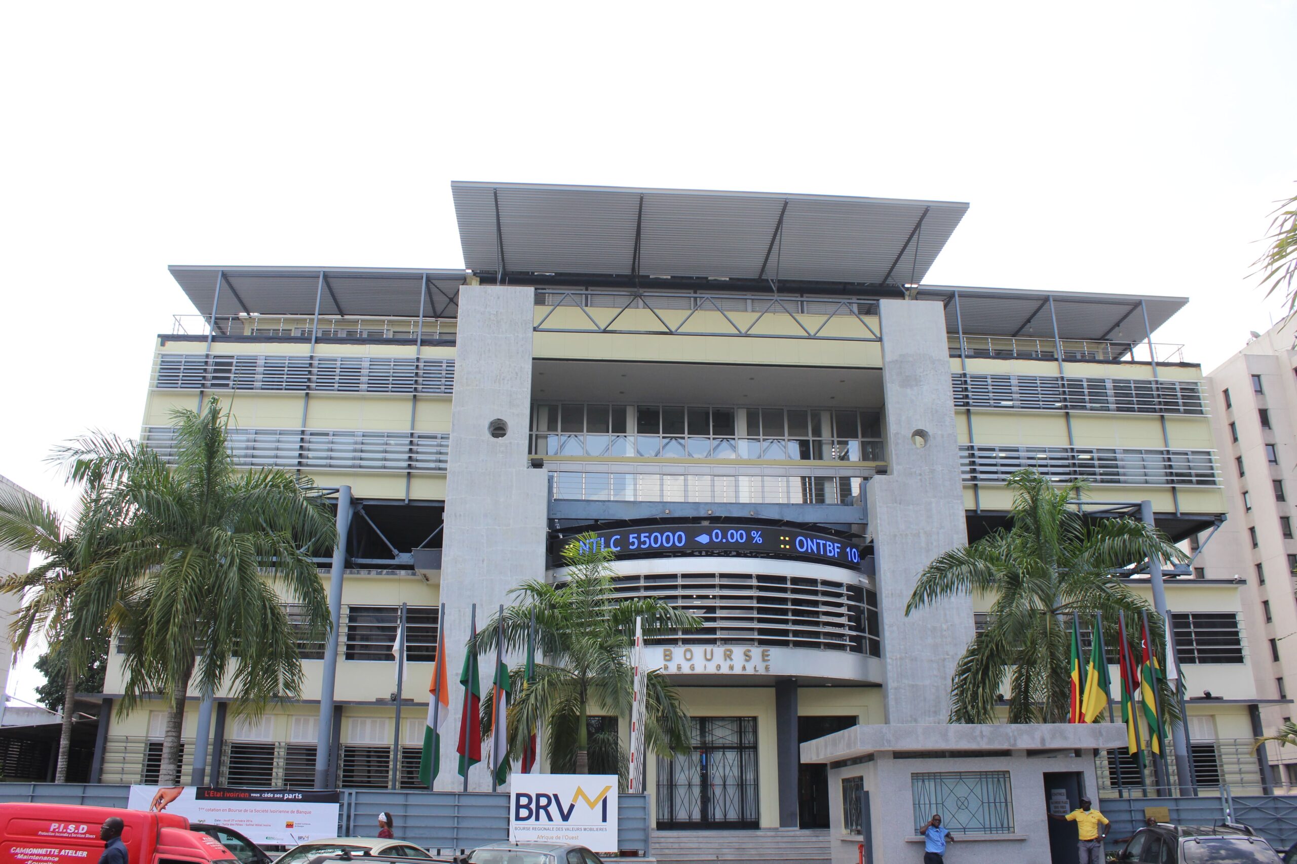 Office building in Africa with modern architecture and multiple flags.