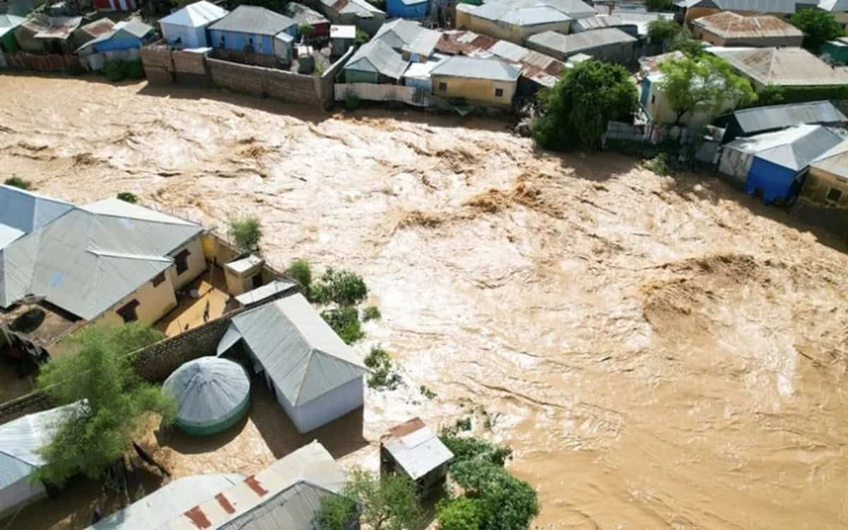 Flooded neighborhood with muddy water covering houses and streets in Africa.