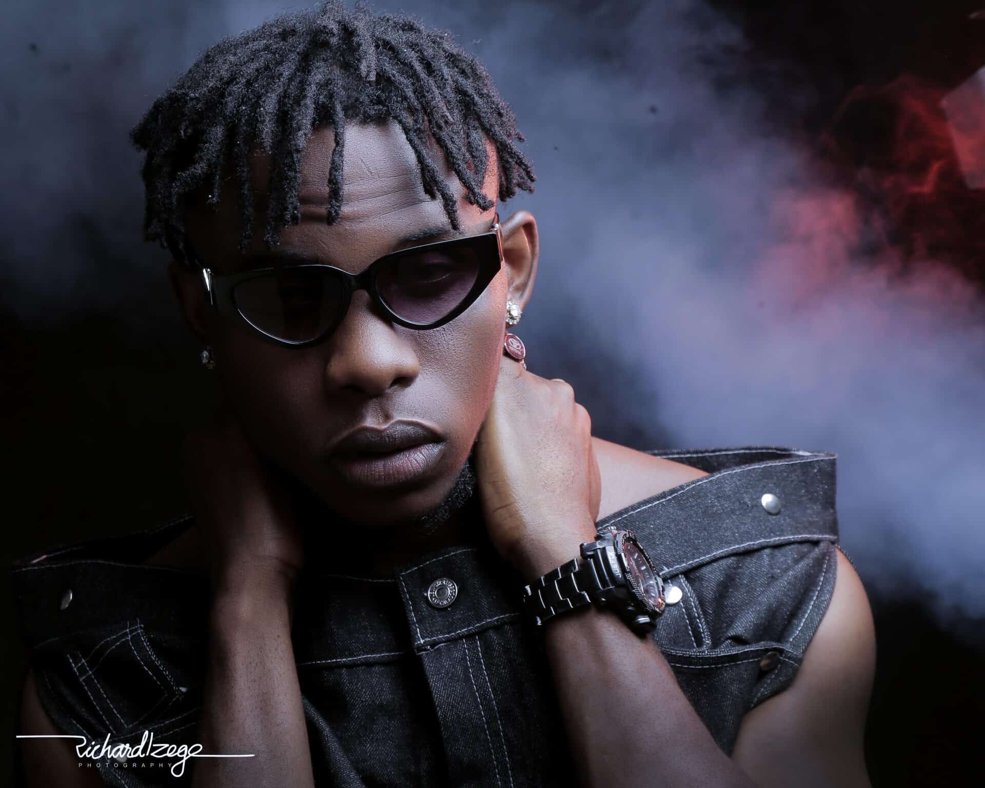 African artist FuzeeJasmine wearing sunglasses and stylish attire.