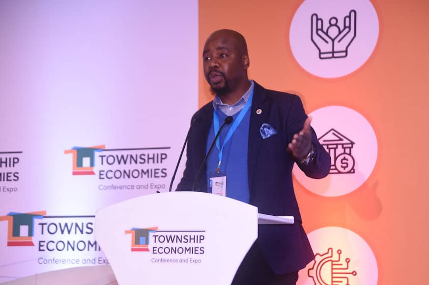 Speaker at township business conference promoting economic growth in townships.