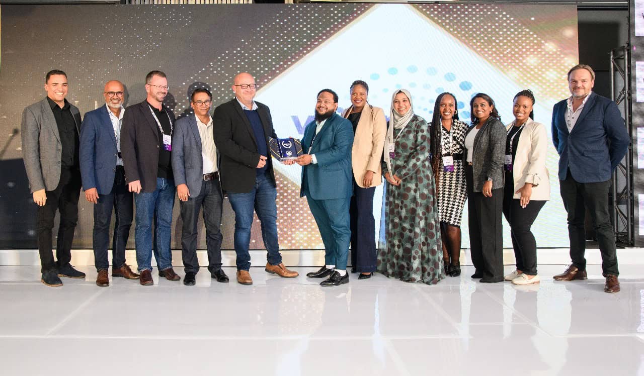 Group of professionals at Connected Banking Summit celebrating innovation.