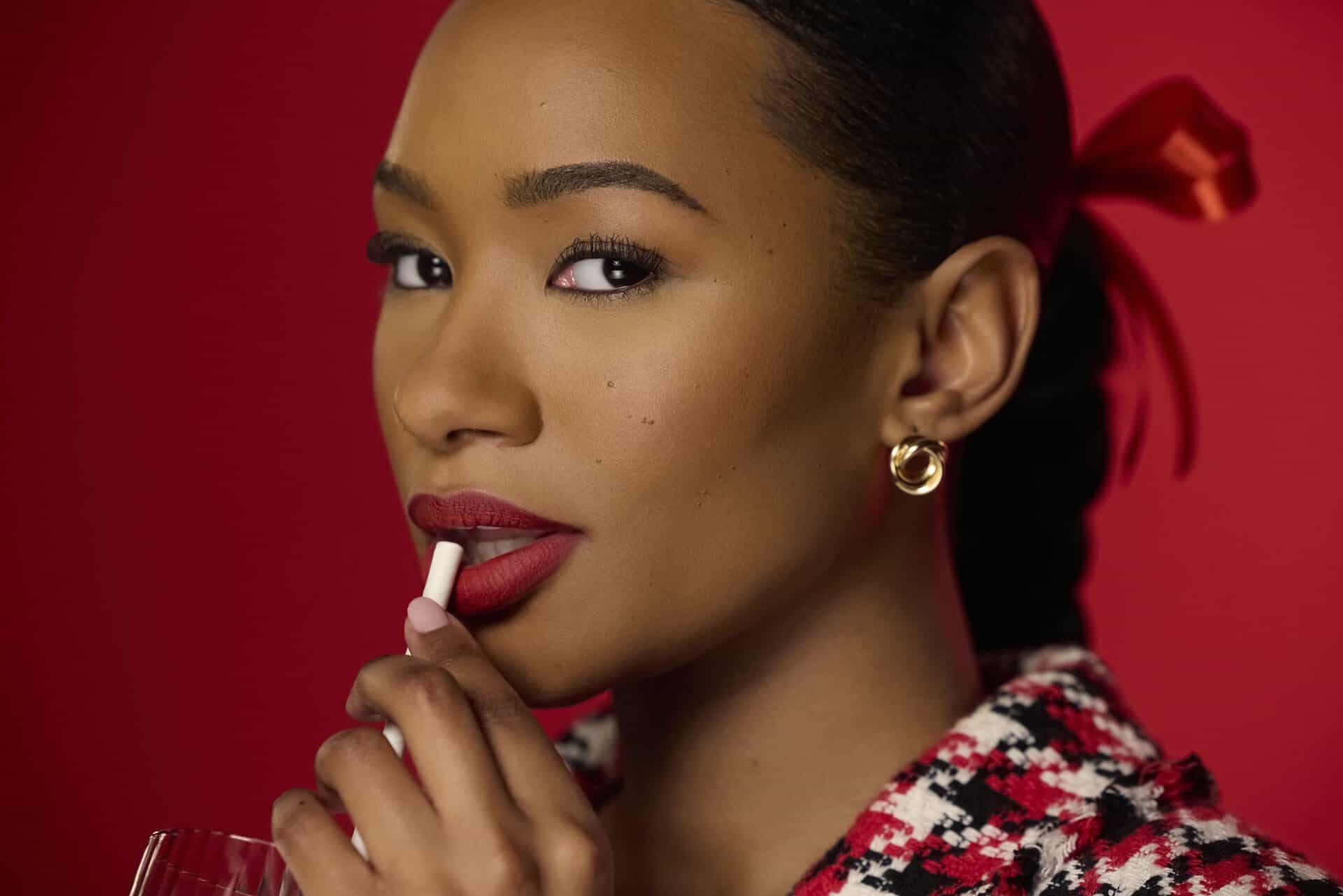 Temi Otedola holding a lipstick, showcasing elegance and confidence for L'Oréal Paris.