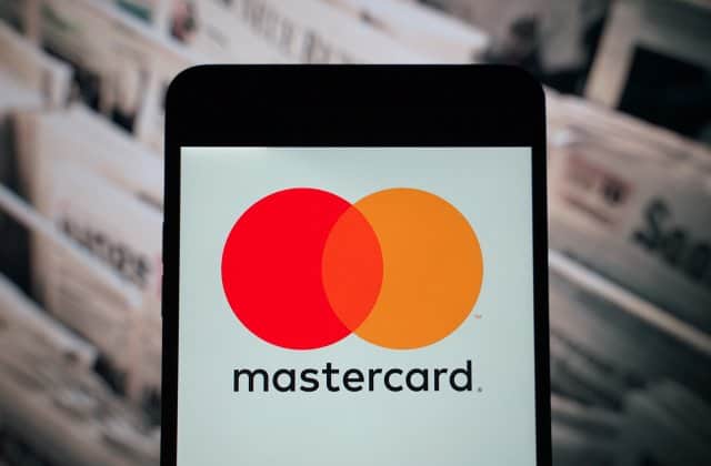 Mastercard logo on mobile device promoting digital payments in Africa.