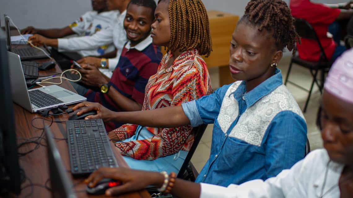 Young Lagos youth learning digital skills in a computer training workshop.