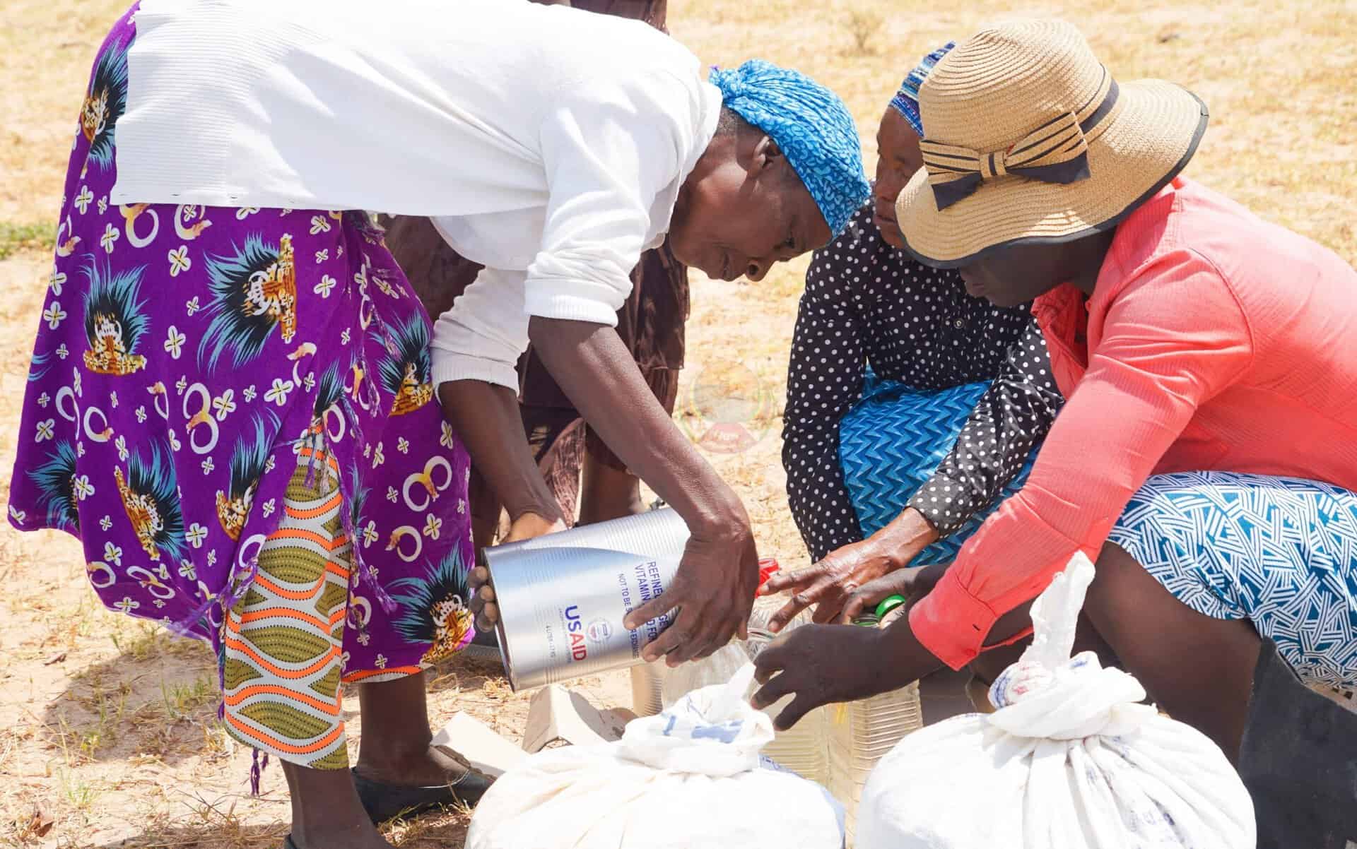 Women receiving food supplies during aid distribution in Zimbabwe.