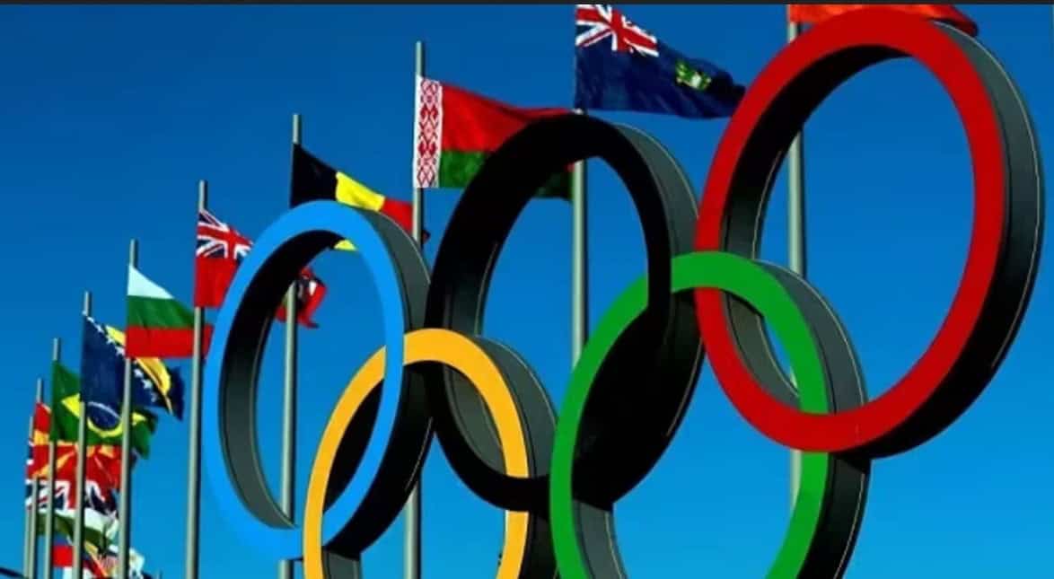 Flags of various countries with Olympic rings symbolizing international sports and unity.
