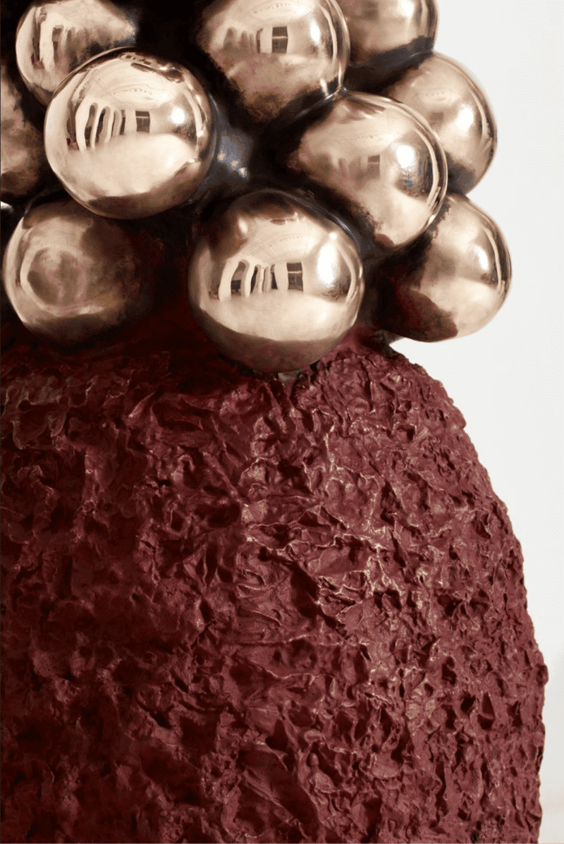 Metallic spheres and textured red background for music video scene.