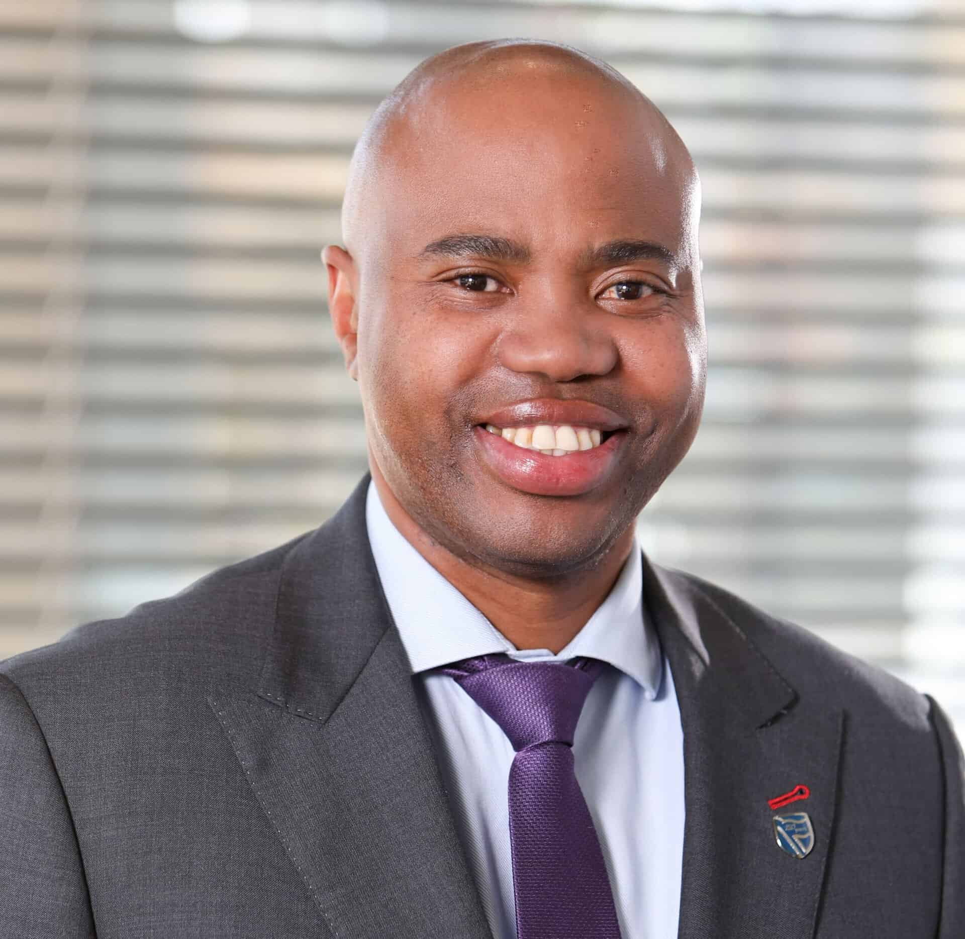 Business professional in suit discussing Africa’s infrastructure needs.