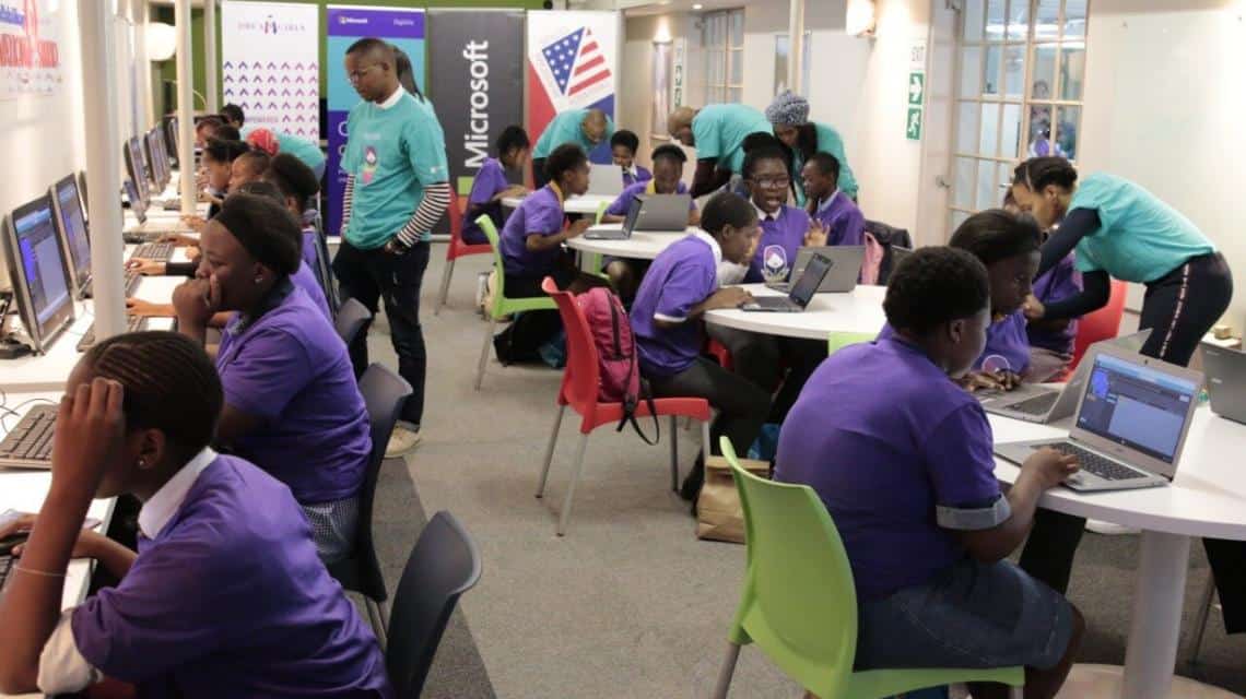 Students engaged in coding and technology training at a South African STEM education workshop.