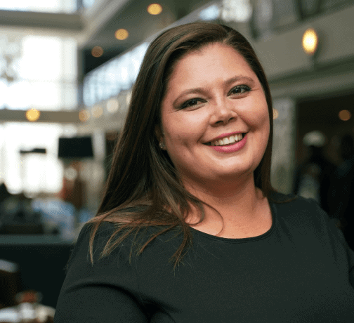 Female executive smiling in a professional setting.