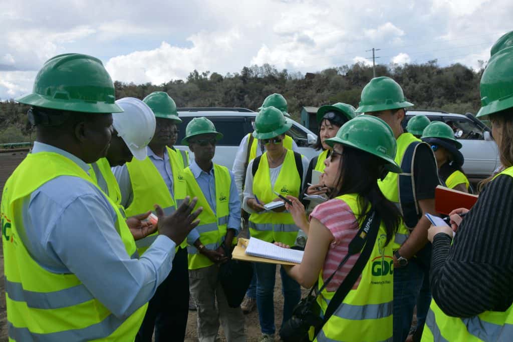 Engineers and officials discuss geothermal equipment at Menengai Power Project site in Kenya.