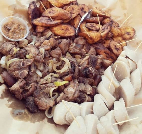Authentic Kinshasa street food featuring grilled meats and skewered snacks.