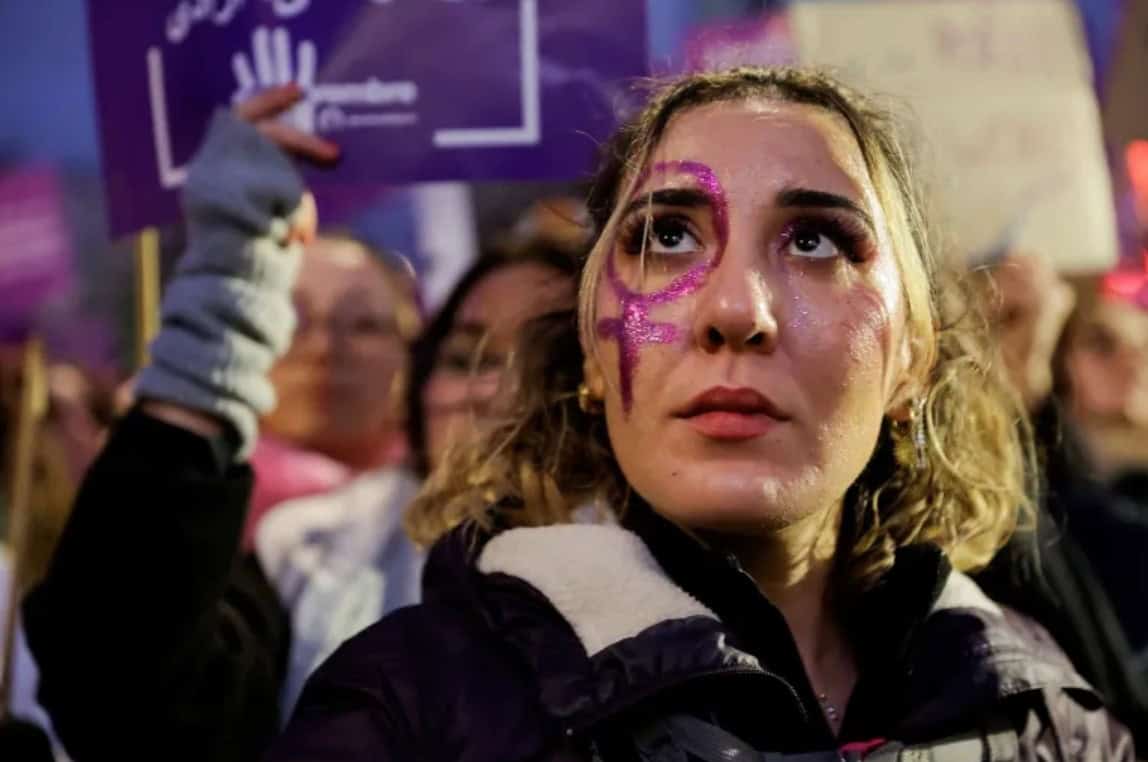 Women protesting domestic violence awareness at a rally.