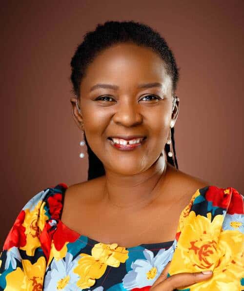 Empowered woman with a bright smile, symbolizing disability inclusion and future leadership.