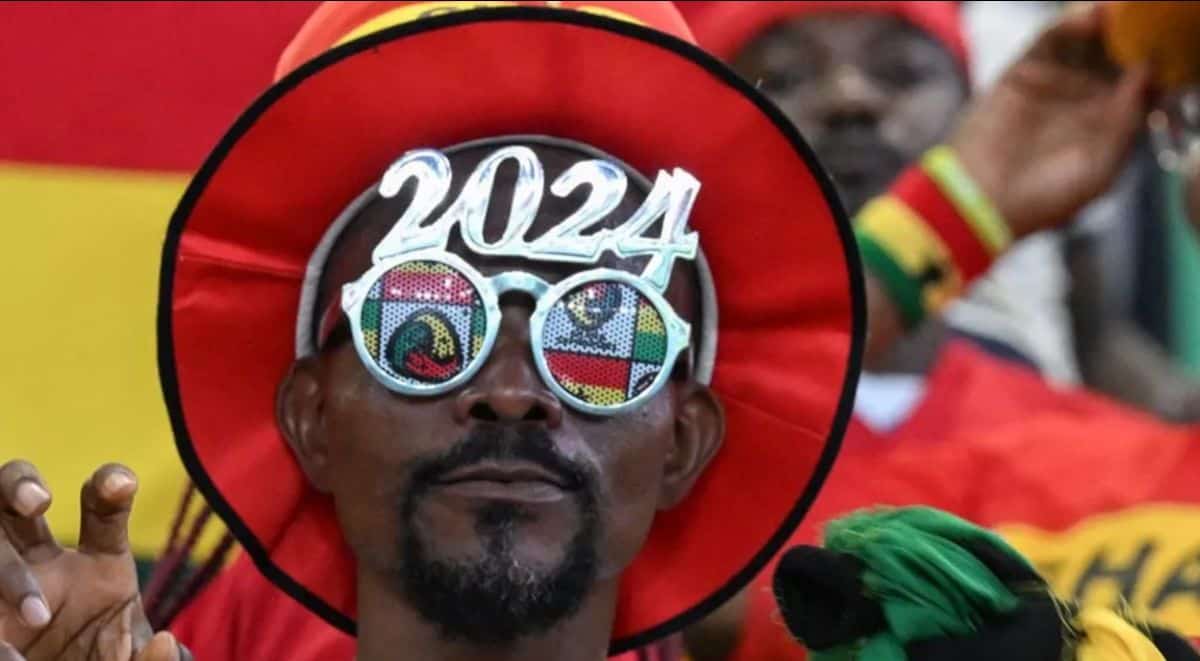 Celebrating Kenya's history with 2024 themed glasses at a cultural event.
