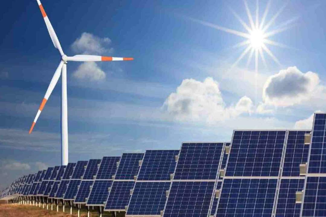 Renewable energy sources including wind turbines and solar panels support sustainable energy transit.