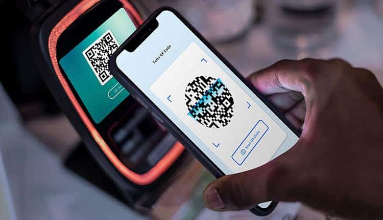 Person scanning a QR code on a smartphone for digital services in Africa.