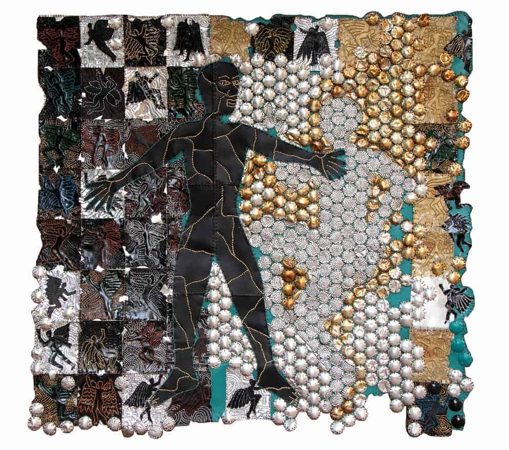 African art installation featuring a human figure surrounded by intricate patterns and metallic embe.