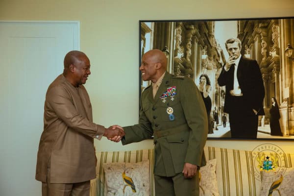 African leaders shaking hands during official diplomatic event.