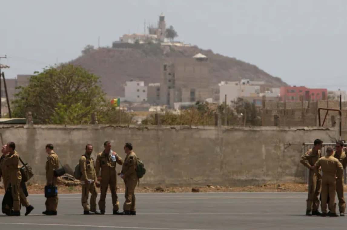 Security personnel standing at the border of the Democratic Republic of Congo.