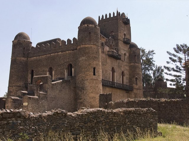 Ancient African fortress featuring towering walls and battlements, showcasing iconic landmarks to vi.