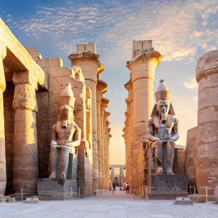 The Top 5 Places To Visit In This African Country 1 Majestic ancient Egyptian statues and towering columns at a historic temple site.