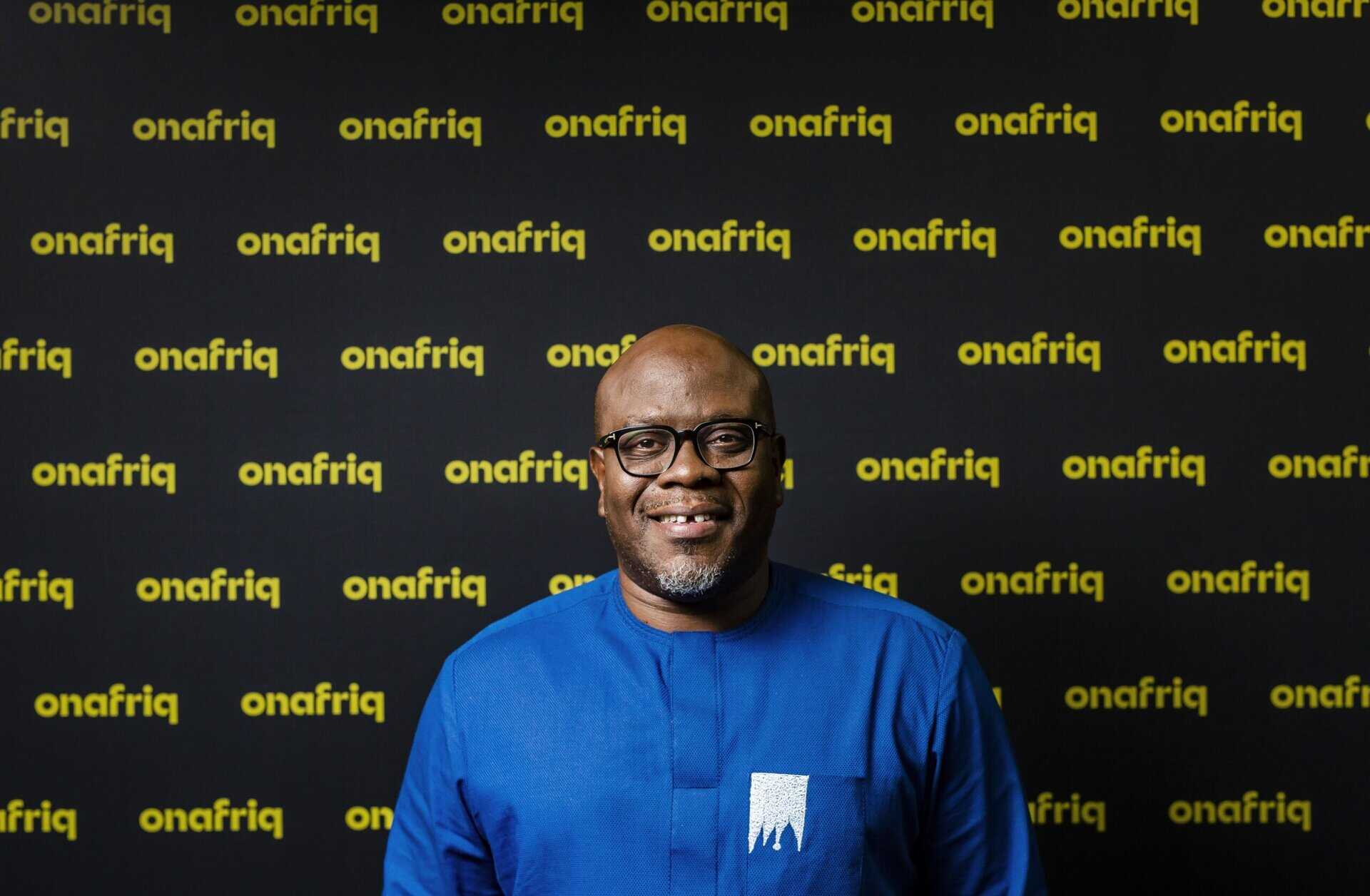 Man smiling in front of Onafriq and Circle partnership backdrop for remittances.